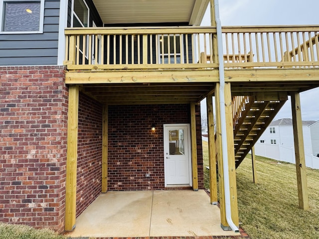 view of exterior entry featuring a patio and a yard