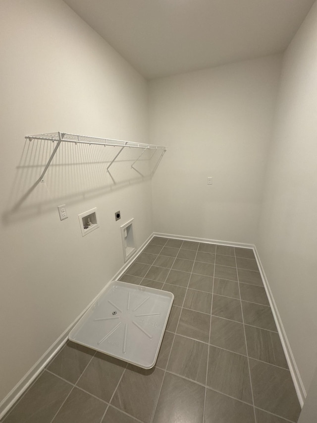 clothes washing area with washer hookup, hookup for an electric dryer, and dark tile patterned floors