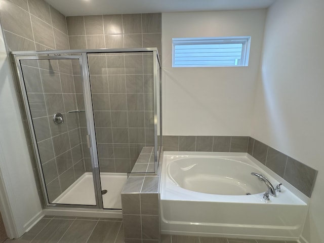 bathroom with shower with separate bathtub