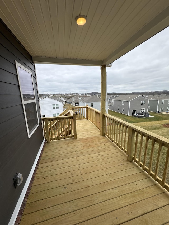 wooden terrace featuring a yard