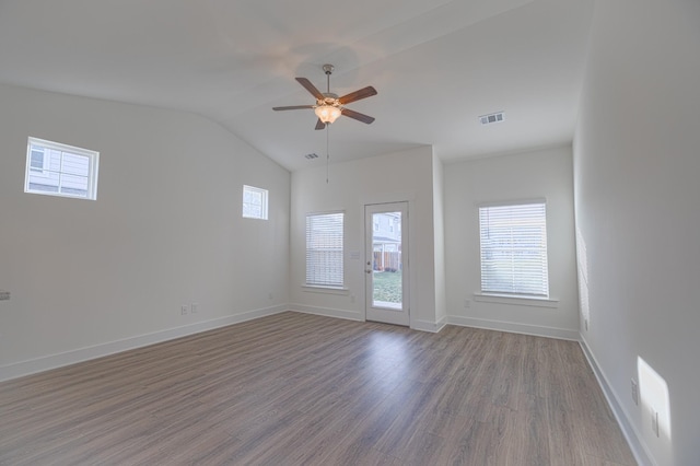 empty room featuring hardwood / wood-style flooring, ceiling fan, and lofted ceiling