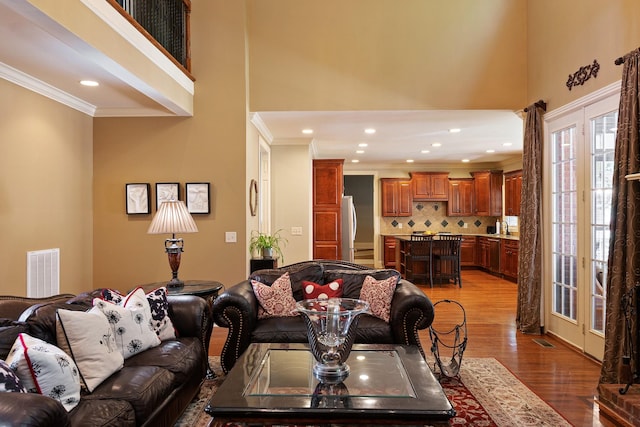 living room with crown molding and dark hardwood / wood-style floors