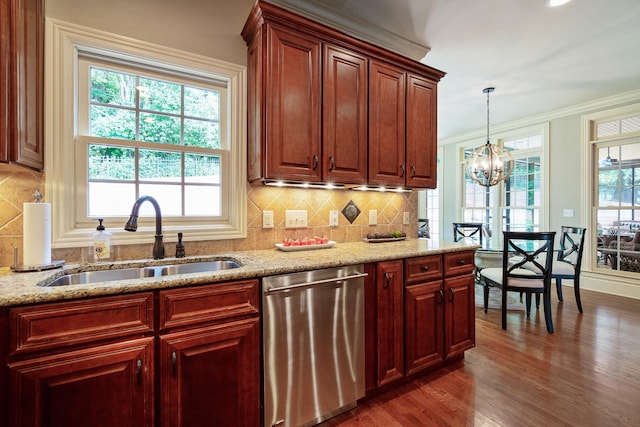 kitchen with dishwasher, sink, hanging light fixtures, light stone counters, and a chandelier