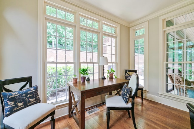 interior space with hardwood / wood-style flooring and ornamental molding