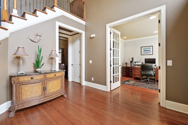 interior space with crown molding, french doors, and dark wood-type flooring