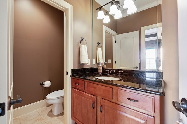 bathroom featuring tile patterned flooring, vanity, toilet, and ornamental molding