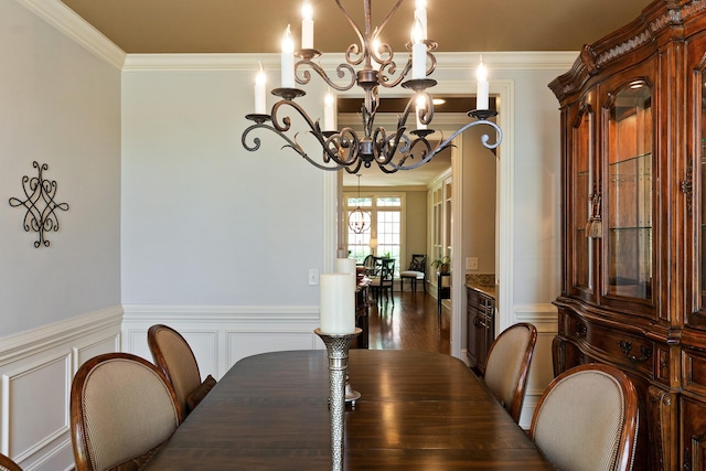 dining room with ornamental molding and a chandelier