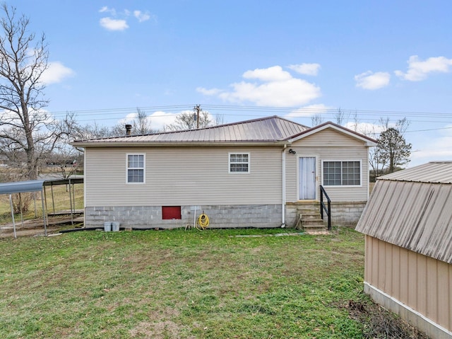 rear view of property featuring a yard