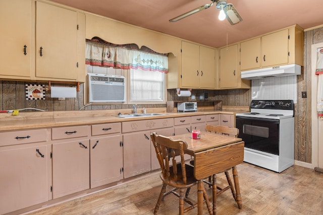 kitchen featuring light wood-type flooring, a wall unit AC, ceiling fan, sink, and white electric range