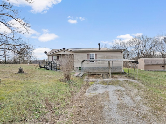 back of house with a lawn and a storage shed