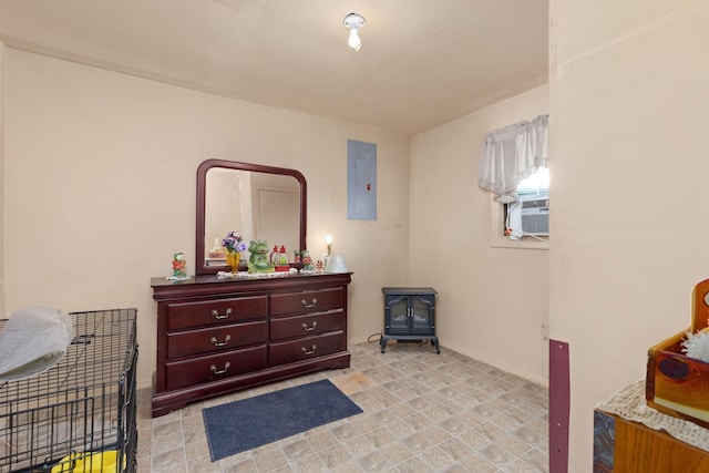 interior space featuring electric panel, a wood stove, and cooling unit