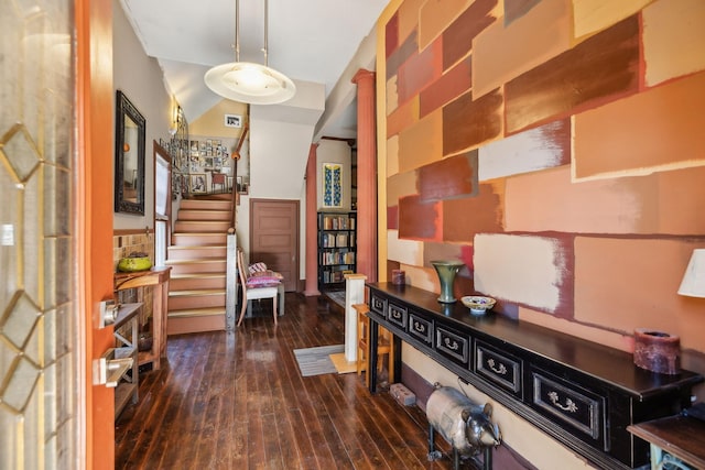 hallway featuring lofted ceiling and dark wood-type flooring