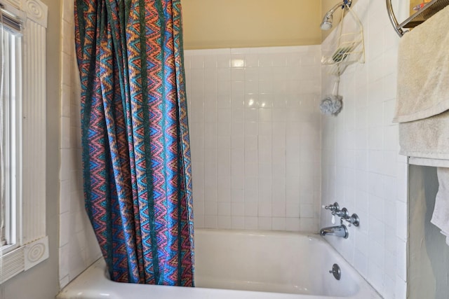 bathroom with shower / bath combo with shower curtain