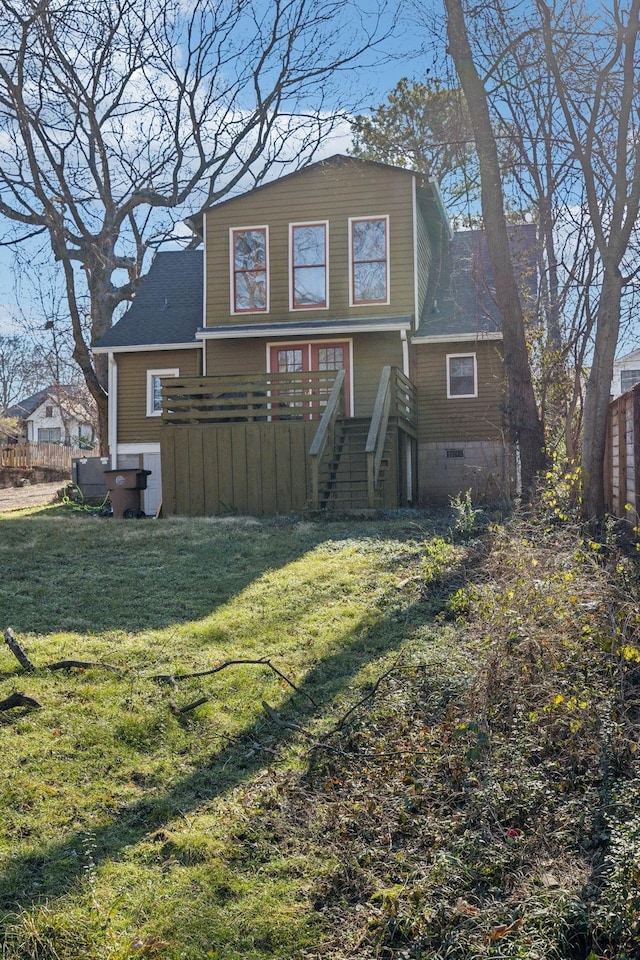 back of house featuring a deck and a lawn