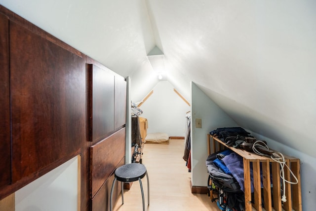 bonus room featuring light wood-type flooring and lofted ceiling