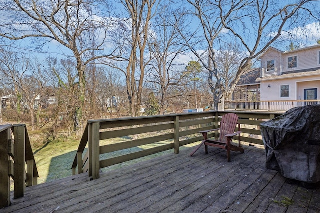 wooden deck with a grill