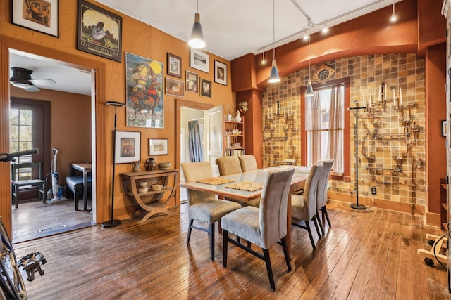 dining area with hardwood / wood-style flooring, ceiling fan, and rail lighting