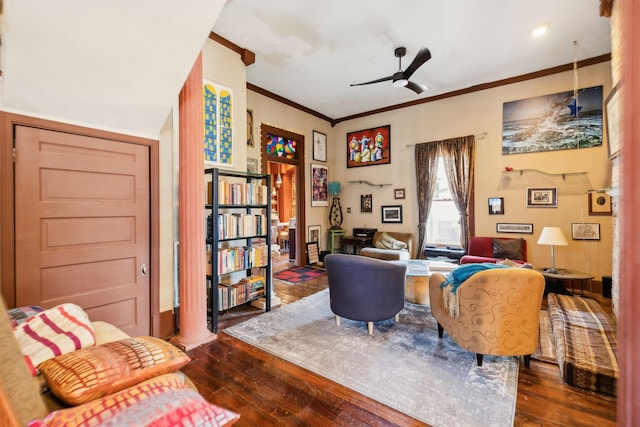 living room featuring crown molding, ceiling fan, dark wood-type flooring, and ornate columns