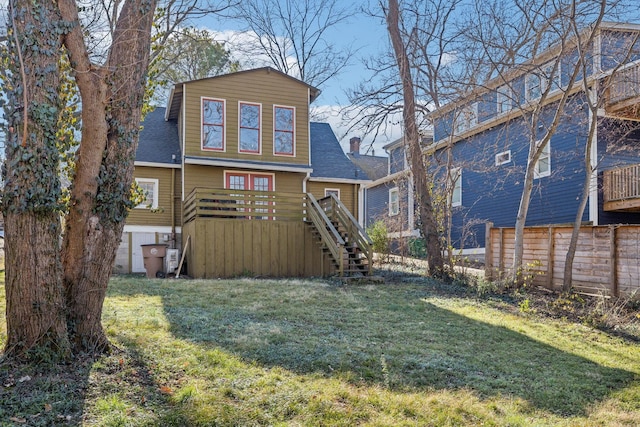 back of house featuring a yard and a wooden deck