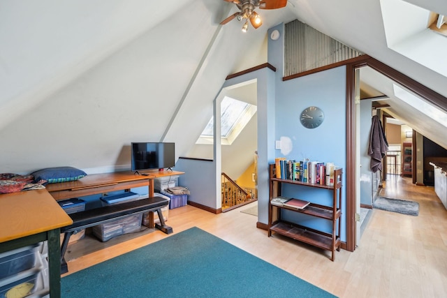 home office with light hardwood / wood-style flooring, vaulted ceiling, and ceiling fan