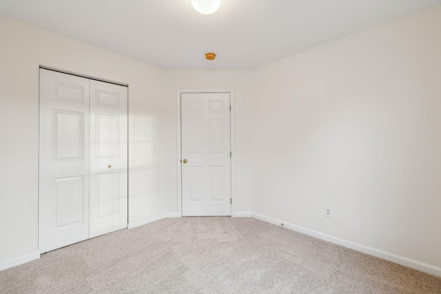 unfurnished bedroom featuring a closet and carpet