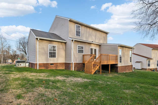 rear view of property featuring a yard and a wooden deck