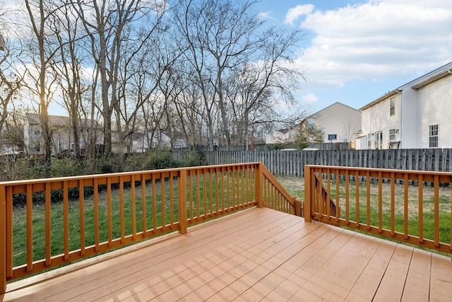 wooden terrace featuring a yard