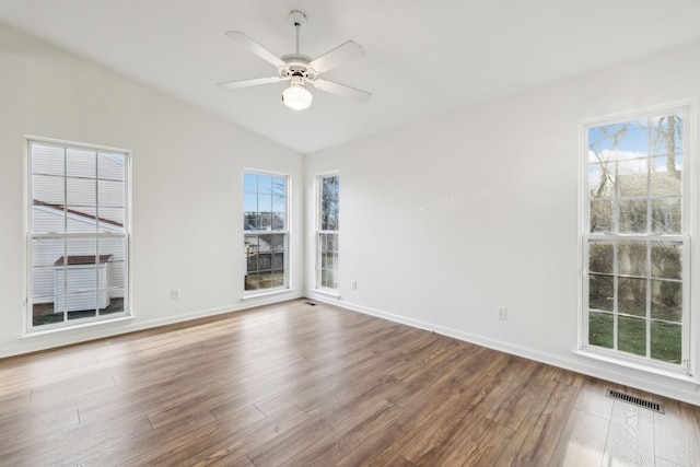 spare room with hardwood / wood-style flooring, ceiling fan, and vaulted ceiling