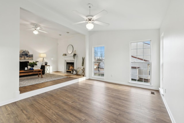 unfurnished living room with ceiling fan, wood-type flooring, and lofted ceiling