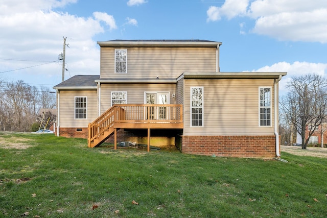 rear view of property with a lawn and a wooden deck