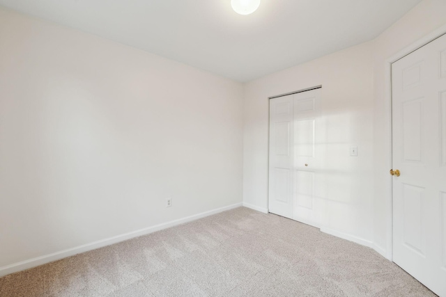 unfurnished bedroom with carpet and a closet