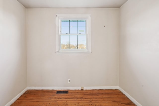 empty room with hardwood / wood-style flooring