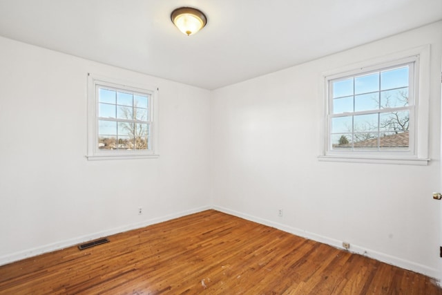 empty room with hardwood / wood-style flooring