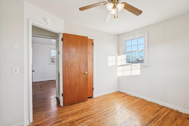 unfurnished bedroom featuring a closet, ceiling fan, and hardwood / wood-style floors