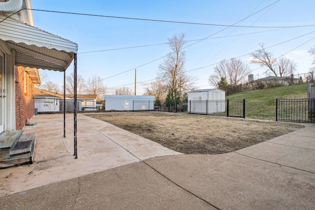 view of yard with a patio area and a storage shed