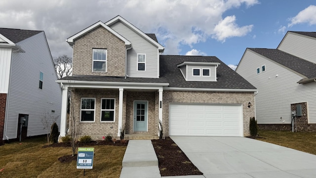 view of front of property with a garage and a front yard