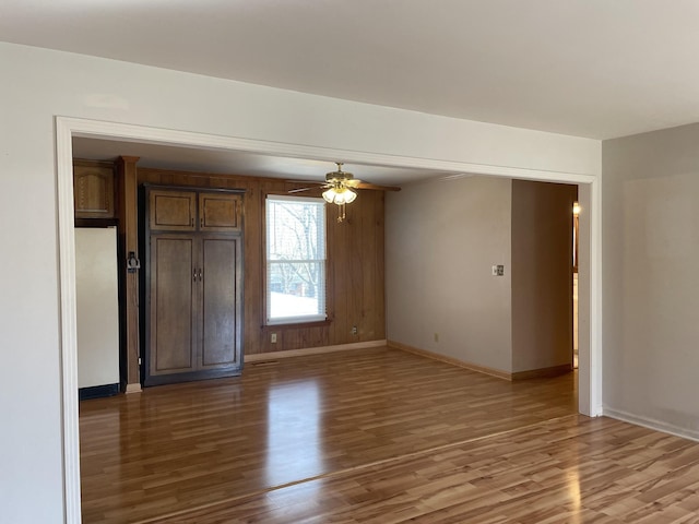 unfurnished room with hardwood / wood-style flooring and ceiling fan