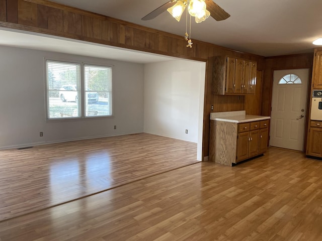 kitchen featuring oven, light hardwood / wood-style flooring, and ceiling fan