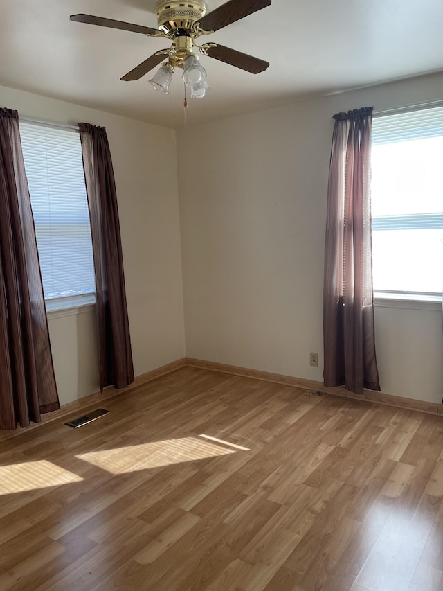 spare room with ceiling fan and light hardwood / wood-style flooring