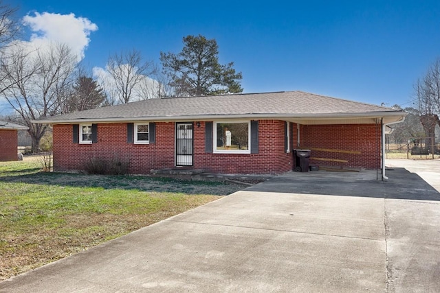 ranch-style home featuring a front yard and a carport