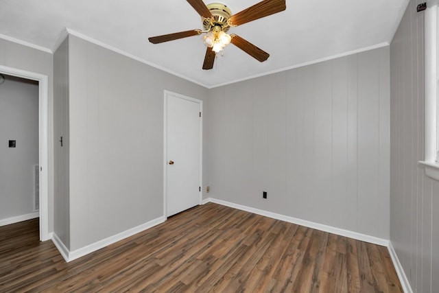 unfurnished bedroom featuring ceiling fan, dark hardwood / wood-style flooring, and crown molding