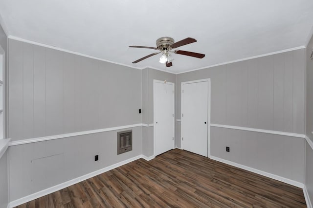 empty room featuring dark hardwood / wood-style flooring, ceiling fan, and ornamental molding