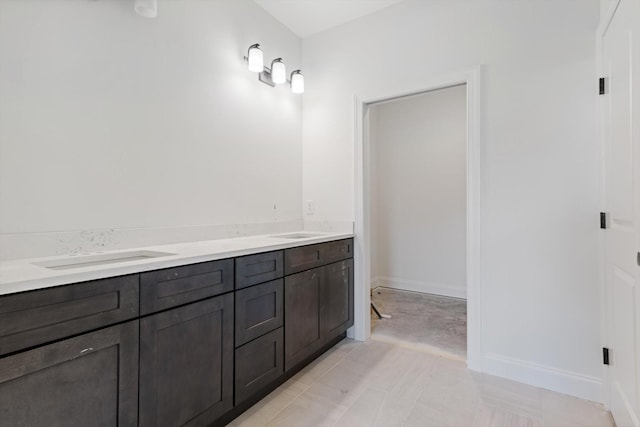 bathroom with tile patterned flooring and vanity