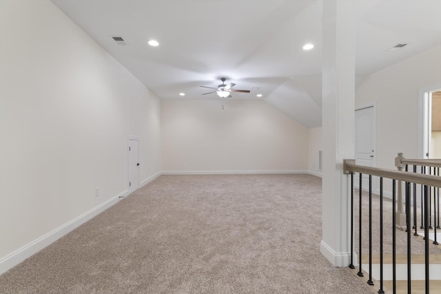 carpeted empty room with vaulted ceiling and ceiling fan