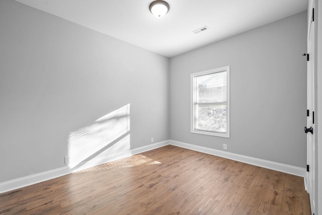 empty room featuring hardwood / wood-style flooring