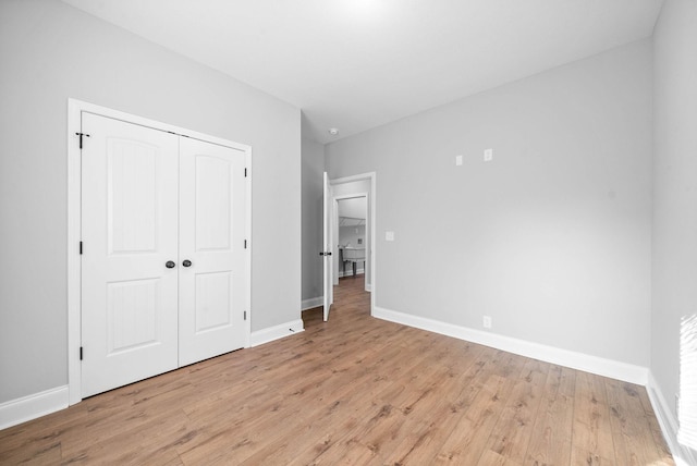 unfurnished bedroom with light hardwood / wood-style floors and a closet