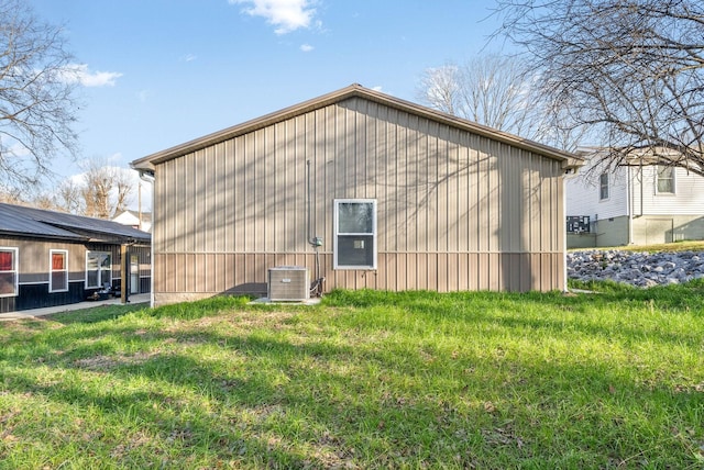 view of home's exterior with a lawn and cooling unit