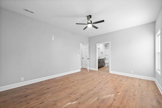 unfurnished bedroom with light hardwood / wood-style flooring, ensuite bath, and ceiling fan