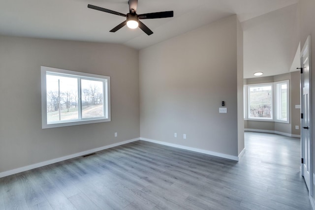 empty room featuring light wood-type flooring, ceiling fan, and lofted ceiling