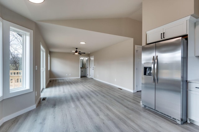 kitchen with white cabinets, stainless steel refrigerator with ice dispenser, vaulted ceiling, and ceiling fan